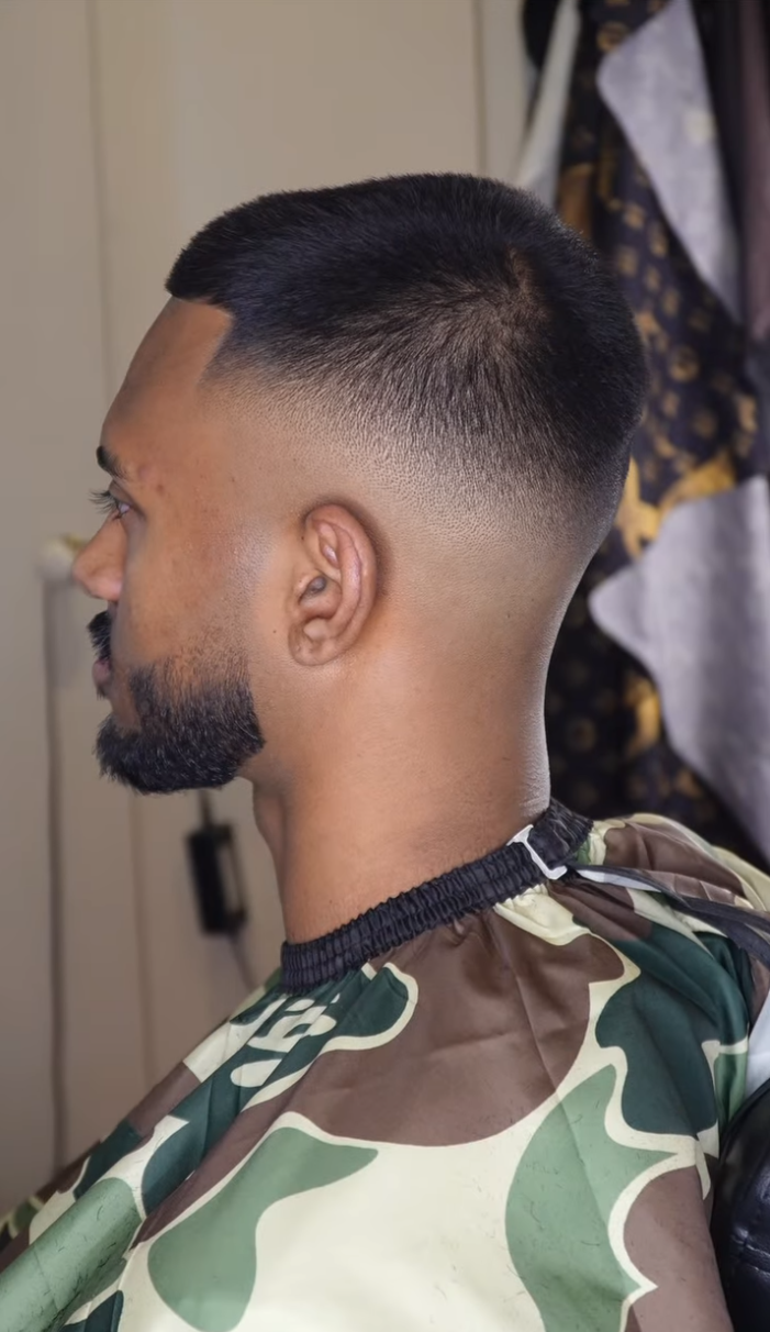 Camo cape haircut with a clean skin fade