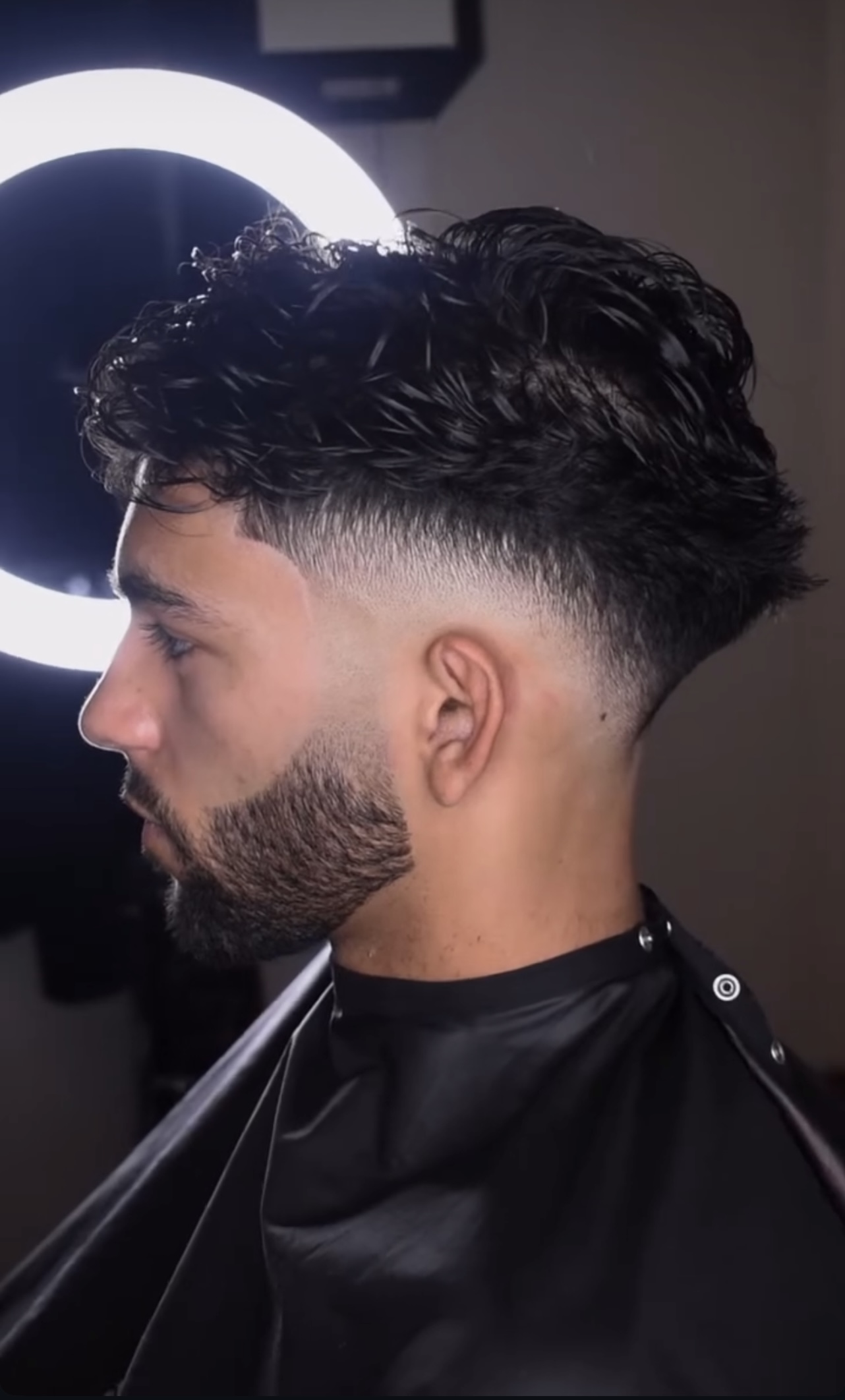 Finished curly fade with a sharp beard line-up