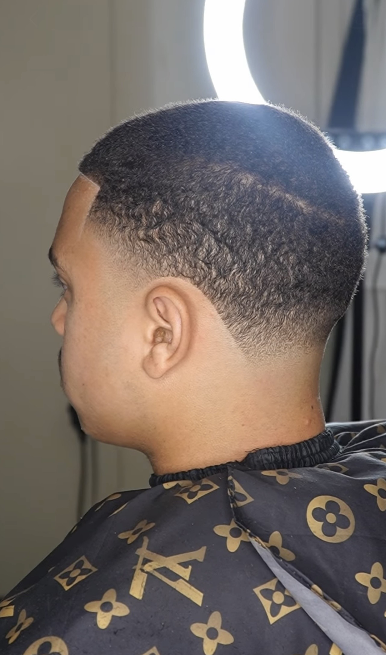 Close side view of a sharp fade and line-up